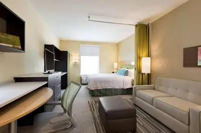 a hotel room with a bed and a living room at Home2 Suites by Hilton Cincinnati Liberty Township in Wetherington