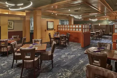 a restaurant with tables and chairs and a bar at DoubleTree by Hilton Akron Fairlawn in Fairlawn