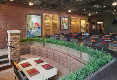 a restaurant with tables and chairs in a building at DoubleTree by Hilton Akron Fairlawn in Fairlawn