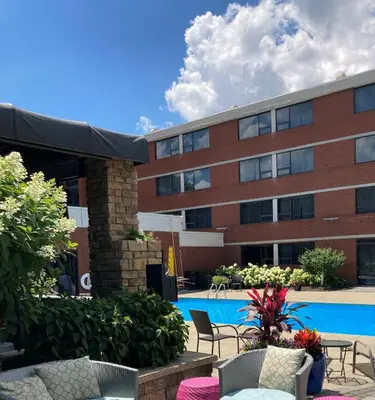 a hotel with a pool in front of a building at DoubleTree by Hilton Akron Fairlawn in Fairlawn