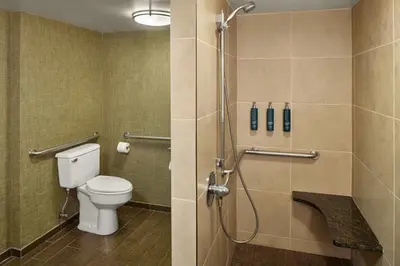 a bathroom with a toilet and a shower stall at DoubleTree by Hilton Akron Fairlawn in Fairlawn
