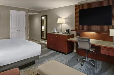 a hotel room with a bed and a desk and a television at DoubleTree by Hilton Akron Fairlawn in Fairlawn