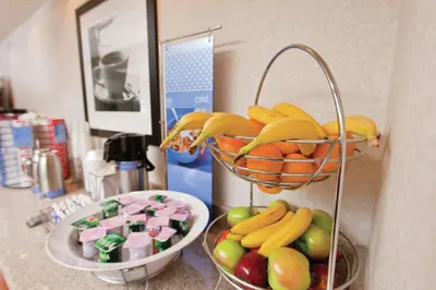 a basket of bananas and apples and a bowl of fruit at Hampton Inn Findlay in Findlay