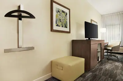 a room with a desk with a tv and a chair at Hampton Inn Findlay in Findlay