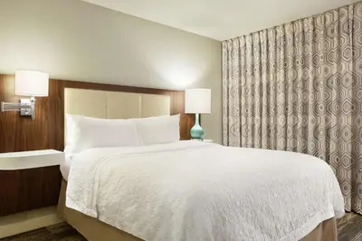 a bedroom with a large white bed and a window at Hampton Inn Findlay in Findlay