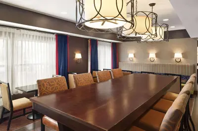 a conference room with a large wooden table and chairs at Hampton Inn Findlay in Findlay