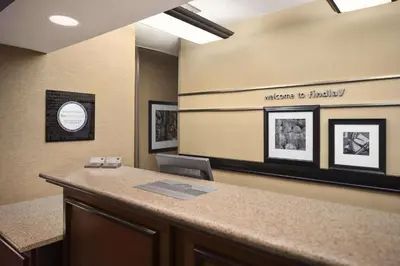 a office with a reception desk with a sign that reads meeting be bricked at Hampton Inn Findlay in Findlay