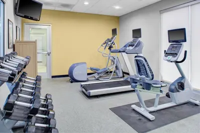 a gym with treadmills and machines in a room at Holiday Inn Hotel & Suites Lima by IHG in Lima