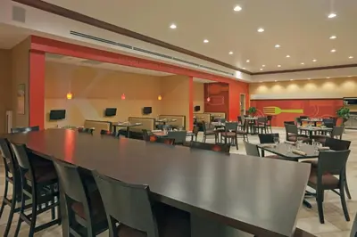 a dining room with a large table and chairs at Holiday Inn Hotel & Suites Lima by IHG in Lima