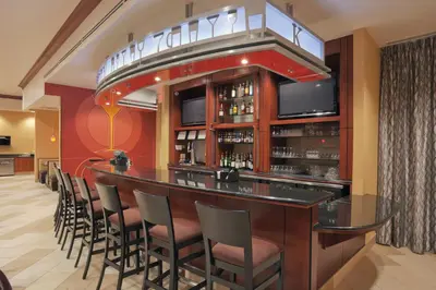a bar in a restaurant with a bunch of chairs at Holiday Inn Hotel & Suites Lima by IHG in Lima
