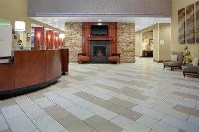 a lobby with a fireplace and a fire place at Holiday Inn Hotel & Suites Lima by IHG in Lima