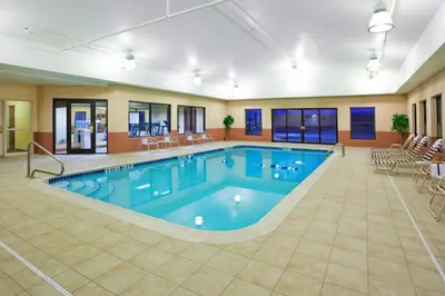 a pool with blue water in a hotel room at Holiday Inn Express Hotel & Suites Cleveland-Streetsboro by IHG in Streetsboro