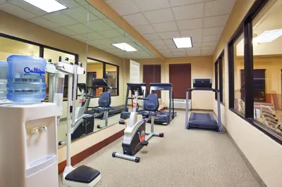 a gym with several treadmills and exercise equipment at Holiday Inn Express Hotel & Suites Cleveland-Streetsboro by IHG in Streetsboro