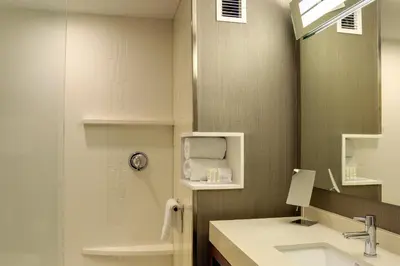 a bathroom with a sink and a mirror at Courtyard by Marriott Columbus OSU in Columbus