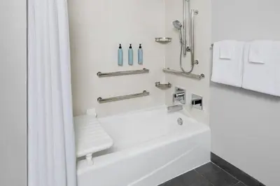 a white bathroom with a tub and a shower at Courtyard by Marriott Columbus OSU in Columbus