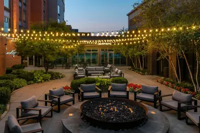 a patio with a fire pit with chairs and lights at Courtyard by Marriott Columbus OSU in Columbus