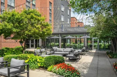 a patio with chairs and umbrellas in a courtyard at Courtyard by Marriott Columbus OSU in Columbus