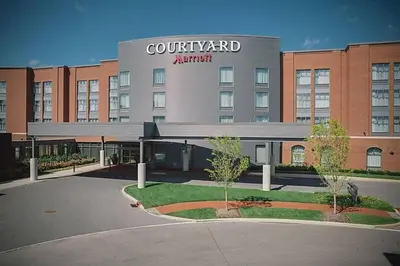 a court yard apartment building with a sign on it at Courtyard by Marriott Columbus OSU in Columbus