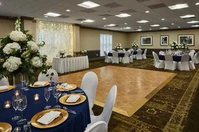 a banquet hall with blue tables and white chairs at Ohio University Inn and Conference Center in Athens