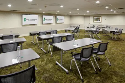 a classroom with tables and chairs in a room at Ohio University Inn and Conference Center in Athens