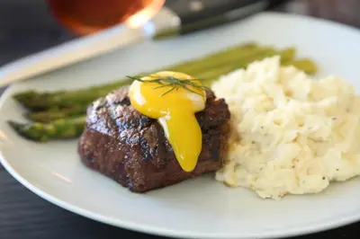 a plate of food with meat and rice and green beans at Ohio University Inn and Conference Center in Athens