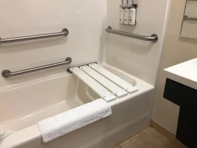 a bathroom with a bath tub with two towels on it at Candlewood Suites Fort Wayne - NW by IHG in Fort Wayne
