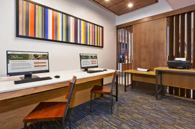 an office with a desk with two computer monitors on it at Holiday Inn Express Hotel & Suites Cleveland-Richfield by IHG in Brecksville
