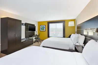 a hotel room with two beds and a television at Holiday Inn Express Hotel & Suites Cleveland-Richfield by IHG in Brecksville