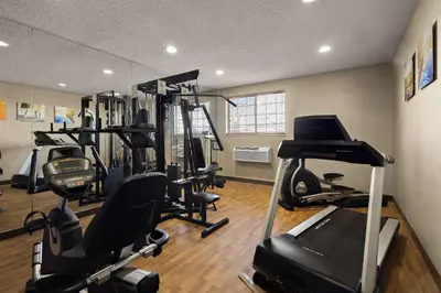 a gym with treadmills and ellipticals in a room at Comfort Inn Near Ouabache State Park in Bluffton
