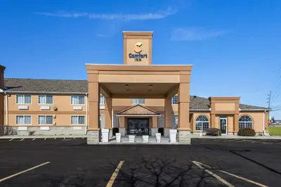 a building with a sign on top of it at Comfort Inn Near Ouabache State Park in Bluffton