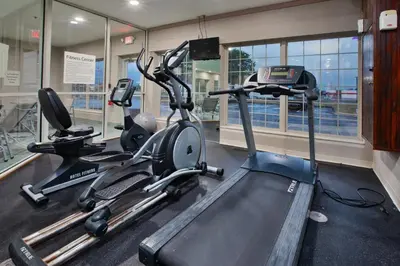 a gym with two exercise bikes and a treadmill at Holiday Inn Express Hotel & Suites Delaware-Columbus Area by IHG in Sunbury
