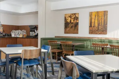 a dining room with tables and chairs at Fairfield Inn and Suites by Marriott Cincinnati Eastgate in Eastgate