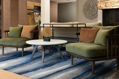 a living room with two chairs and a table and a bunk bed at Fairfield Inn and Suites by Marriott Cincinnati Eastgate in Eastgate