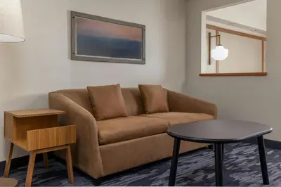 a living room with a couch and a table at Fairfield Inn and Suites by Marriott Cincinnati Eastgate in Eastgate