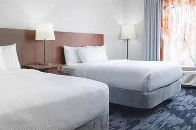 a hotel room with two beds and a window at Fairfield Inn and Suites by Marriott Cincinnati Eastgate in Eastgate