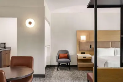 a hotel room with a bed and a chair and a desk at Doubletree By Hilton Columbus Dublin in Dublin