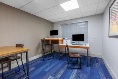 an office with two desks and two monitors at Holiday Inn Express Hotel & Suites Woodhaven by IHG in Woodhaven