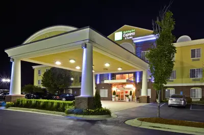a hotel building with a parking garage at night at Holiday Inn Express Hotel & Suites Woodhaven by IHG in Woodhaven