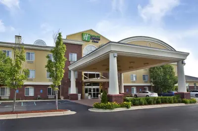 a hotel front of a building with a parking lot at Holiday Inn Express Hotel & Suites Woodhaven by IHG in Woodhaven
