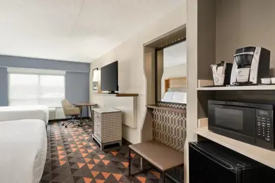 a hotel room with a bed and a television at Holiday Inn Florence by IHG in Florence