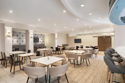 a dining room with tables and chairs at Holiday Inn Florence by IHG in Florence