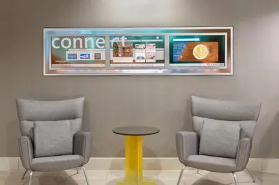 a waiting room with two chairs and a table and a tv at SpringHill Suites by Marriott Cleveland Solon in Solon