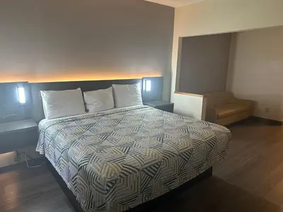 a hotel room with a bed and a chair at Motel 6-Anderson, IN in Anderson