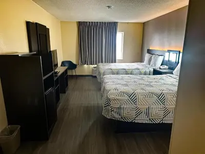 a hotel room with two beds and a television at Motel 6-Anderson, IN in Anderson