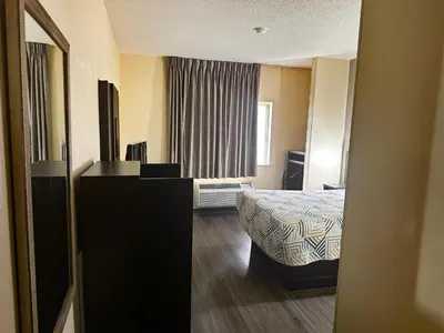 a small hotel room with a bed and a window at Motel 6-Anderson, IN in Anderson