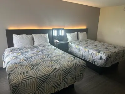 a hotel room with two beds and a phone at Motel 6-Anderson, IN in Anderson