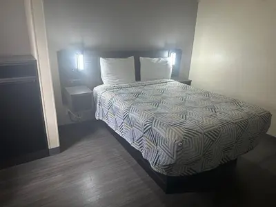 a bed in a hotel room with two pillows at Motel 6-Anderson, IN in Anderson
