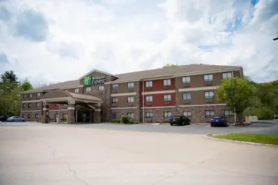 a hotel with a parking lot in front of it at Holiday Inn Express Winfield - Teays Valley by IHG in Hurricane