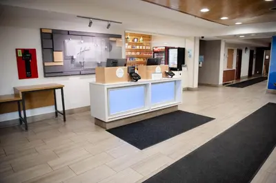 a lobby with a reception desk in a office at Holiday Inn Express Winfield - Teays Valley by IHG in Hurricane