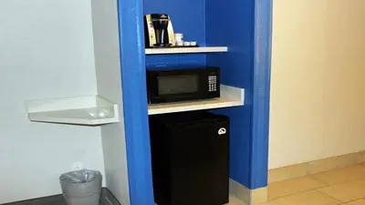 a microwave sitting on a shelf in a room at Holiday Inn Express Winfield - Teays Valley by IHG in Hurricane